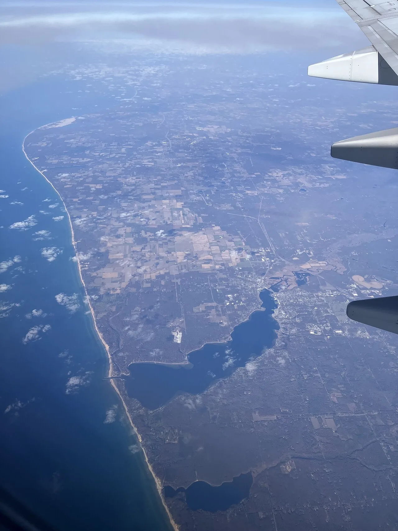 Aerial view of a lake shoreline with visible footpaths